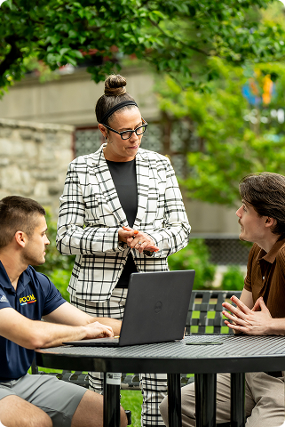 missy terlecki, dean of the school of professional and applied psychology, talking with students at a table