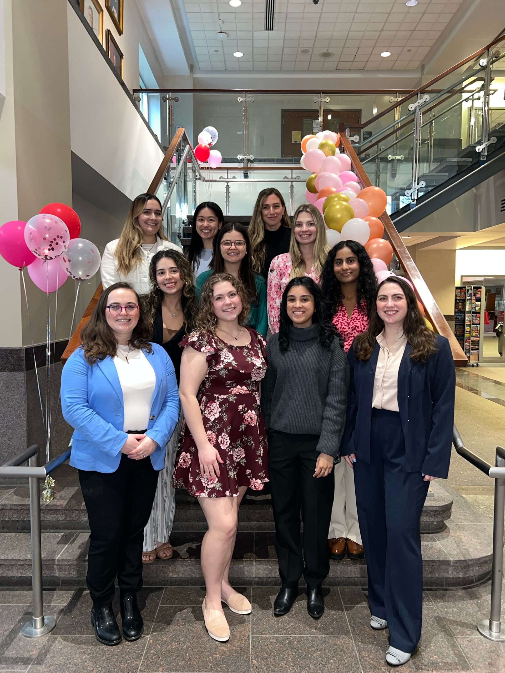 2024 AMWA members posing on the steps during a brunch event